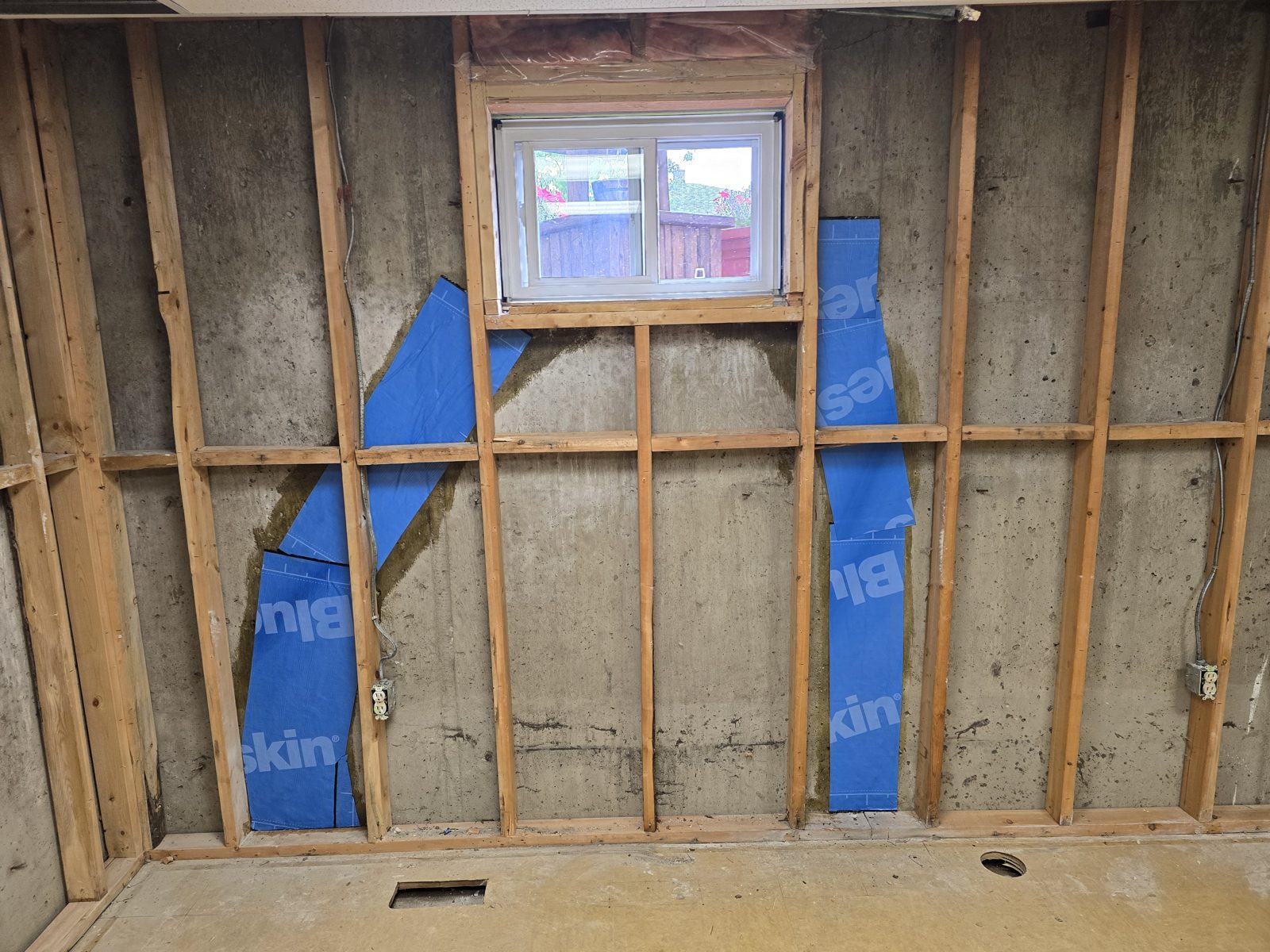 Foundation waterproofing with Blueskin membrane on a basement wall in Edmonton